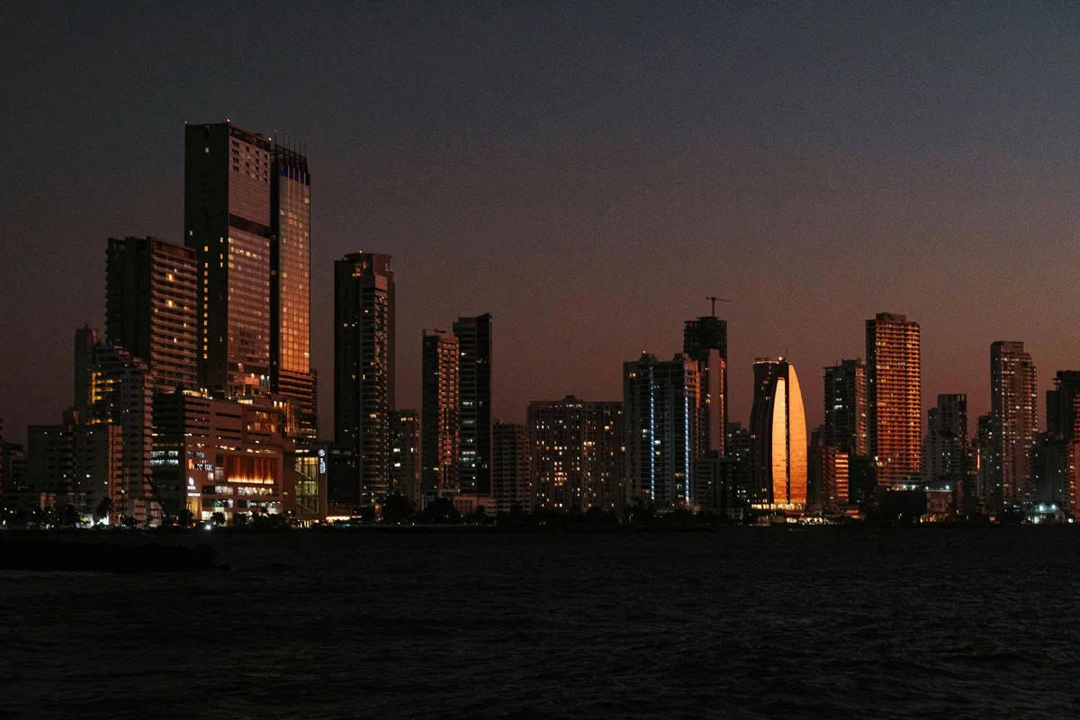 Illuminated Cartagena de Indias skyline at dusk, the Bocagrande high-rise corridor seen across the bay
