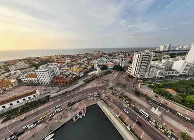 A breathtaking aerial view capturing Cartagena's vibrant streets, historic architecture, and stunning waterfront at sunset.