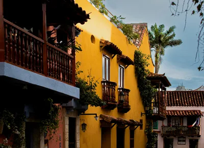 Charming colonial houses in Cartagena with colorful facades and wooden balconies.