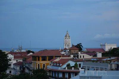 Rooftop view of Cartagena's colorful architecture with the sea in the background.