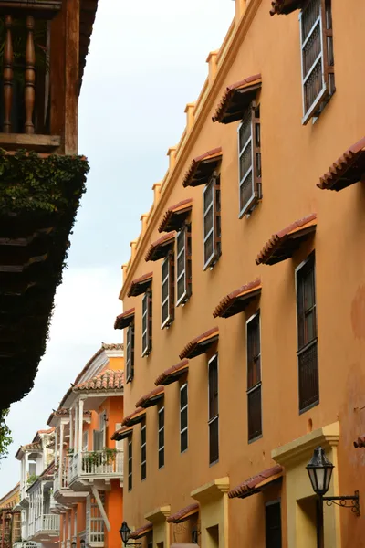 A vibrant view of colonial architecture with colorful facades and open windows on a sunny day.